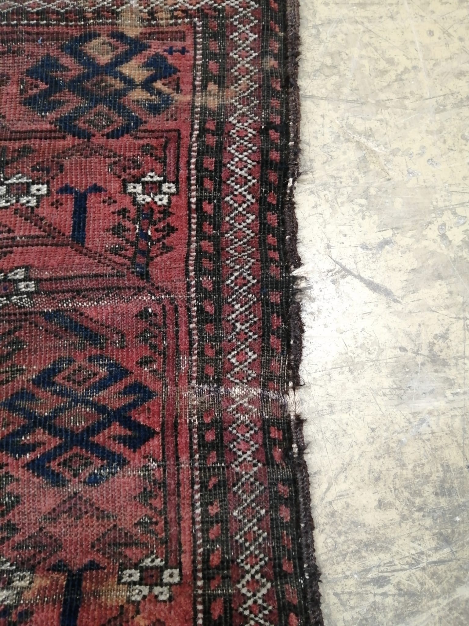An antique Belouch red rug, 140 x 100cm
